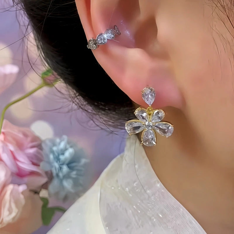 Model showcasing the dangle and style of the 14K Gold-Plated Elegant Zircon Flower Earrings