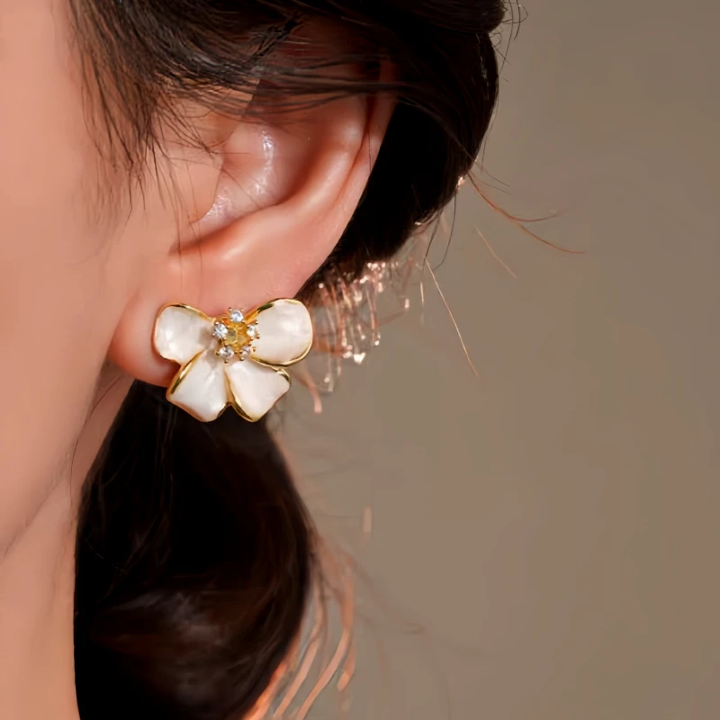 Model showcasing the dangle and style of the 14K Gold-Plated Elegant Zircon Flower Earrings