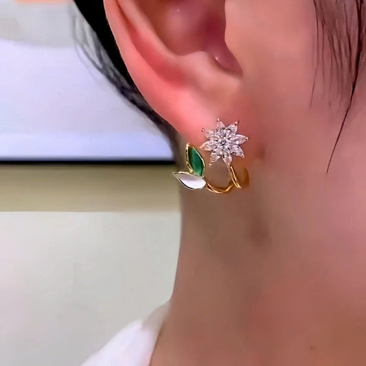 Model showcasing the dangle and style of the 14K Gold-Plated Elegant Zircon Flower Earrings