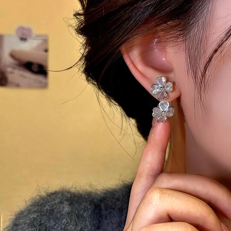 Model showcasing the dangle and style of the 14K Gold-Plated Elegant Zircon Flower Earrings