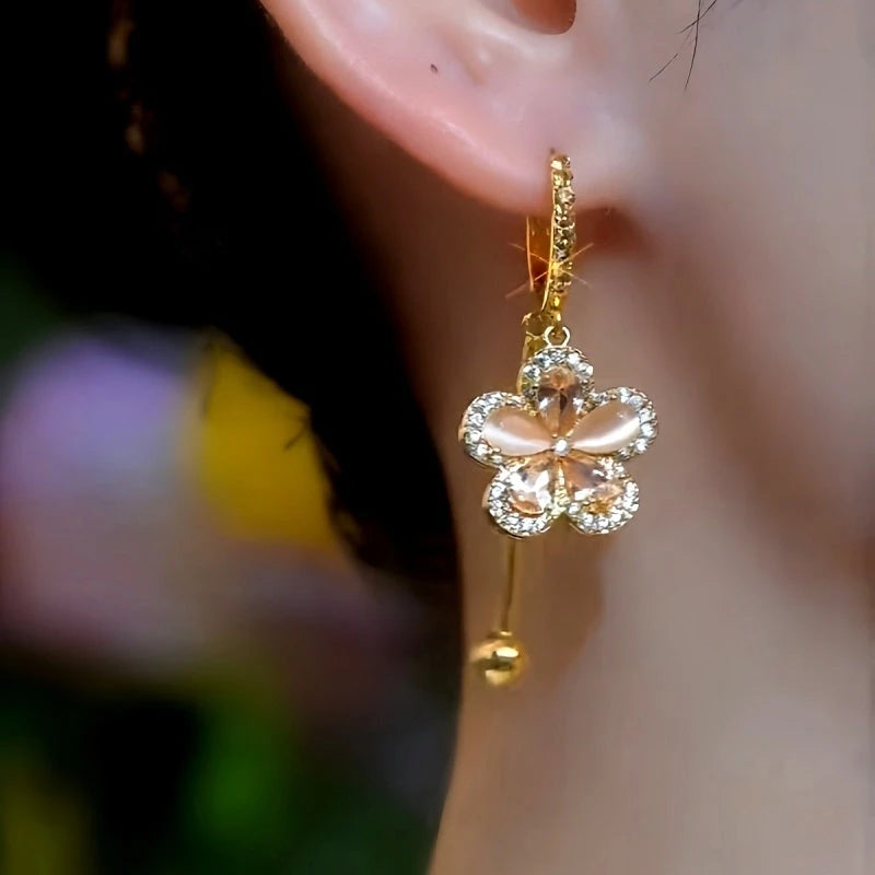 Model showcasing the dangle and style of the 14K Gold-Plated Elegant Zircon Flower Earrings