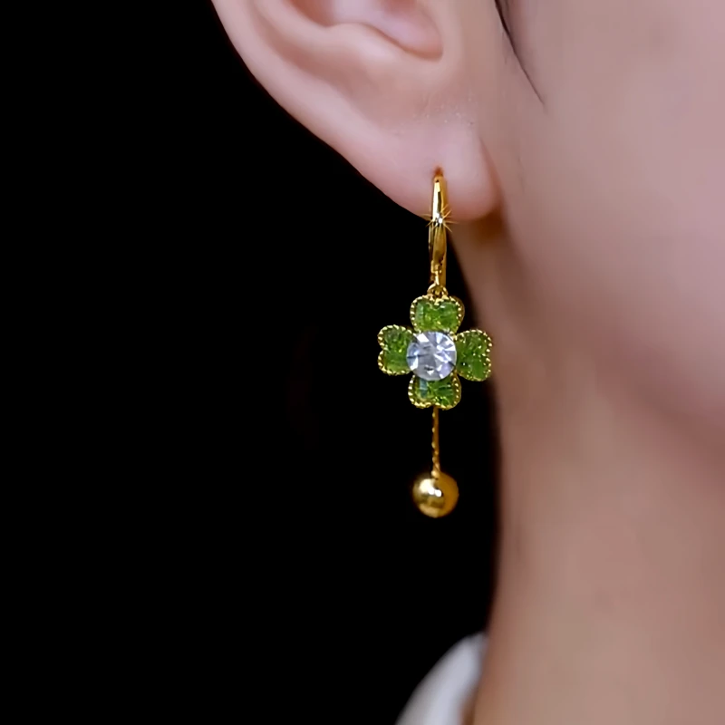 Model showcasing the dangle and style of the 14K Gold-Plated Elegant Zircon Flower Earrings