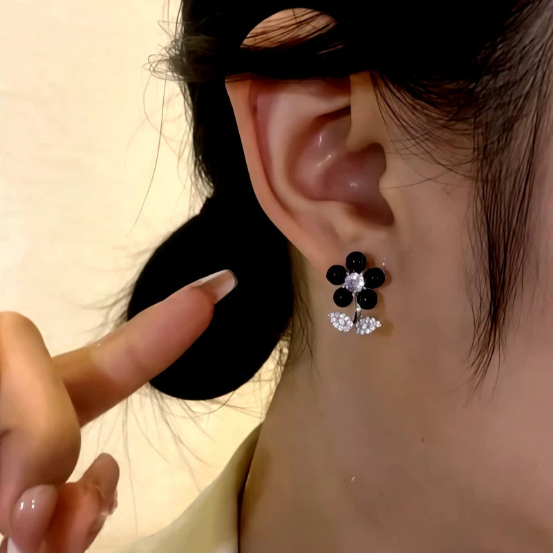 Close-up detail of the sparkling zircons and plating on the Black Flower Earrings