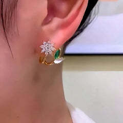 Close-up detail of the sparkling zircons and plating on the gold flower earrings