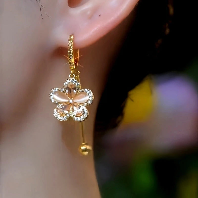 Close-up detail of the sparkling zircons and plating on the gold flower earrings