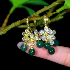 Angled view of the 14K Gold-Plated Elegant Zircon Flower Green Bead Tassel Earrings