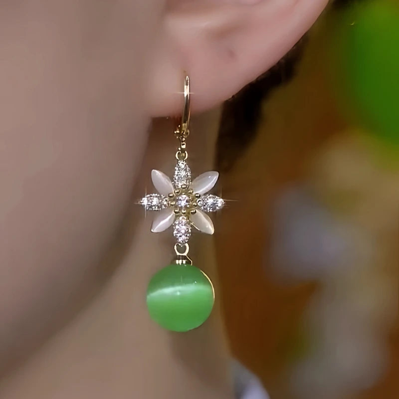 Close-up detail of the sparkling zircons and plating on the gold tassel earrings