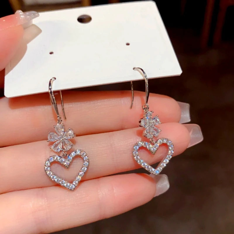 Model showcasing the dangle and style of the 14K Gold-Plated Elegant Zircon Flower Heart Ear Hooks