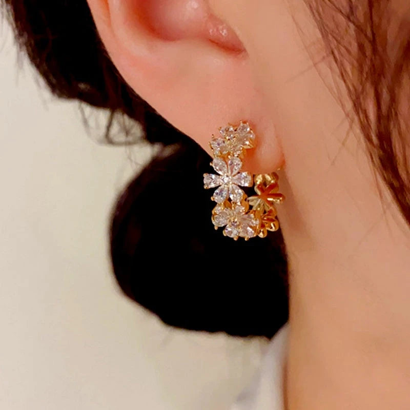 Close-up detail of the sparkling zircons and plating on the gold hoop earrings