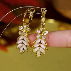 Close-up detail of the sparkling zircons and plating on the gold tassel earrings