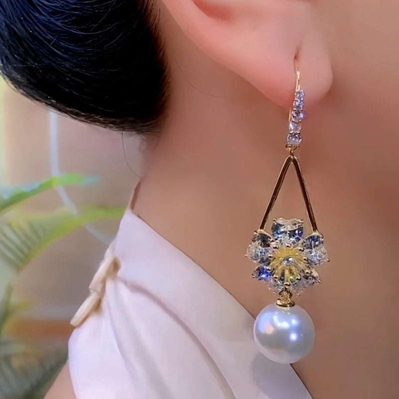 Model showcasing the dangle and style of the 14K Gold-Plated Elegant Zircon Flower Pearl Ear Hook Earrings