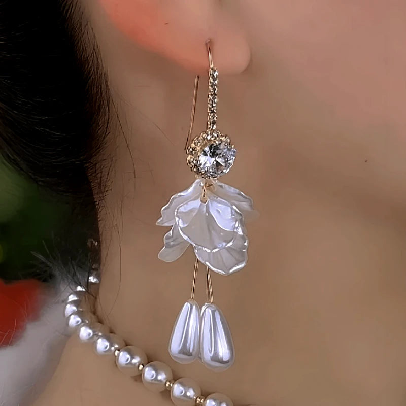 Close-up detail of the sparkling zircons and plating on the gold pearl earrings