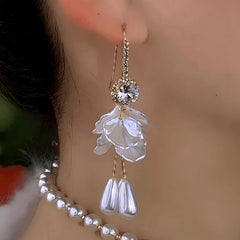 Close-up detail of the sparkling zircons and plating on the gold pearl earrings