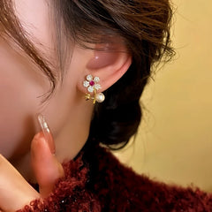 Close-up detail of the sparkling zircons and plating on the gold flower earrings