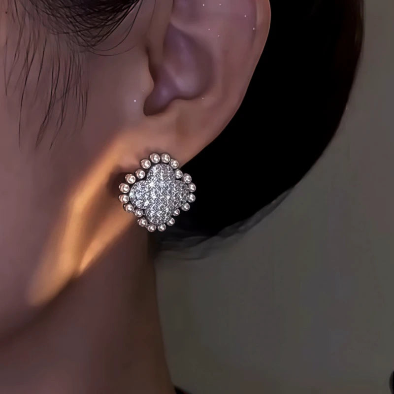 Model showcasing the dangle and style of the 14K Gold-Plated Elegant Zircon Flower Pearl Earrings