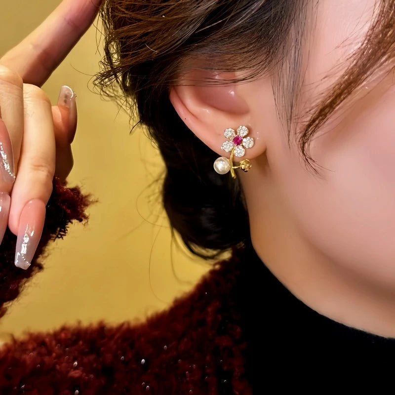 Model showcasing the dangle and style of the 14K Gold-Plated Elegant Zircon Flower Pearl Earrings