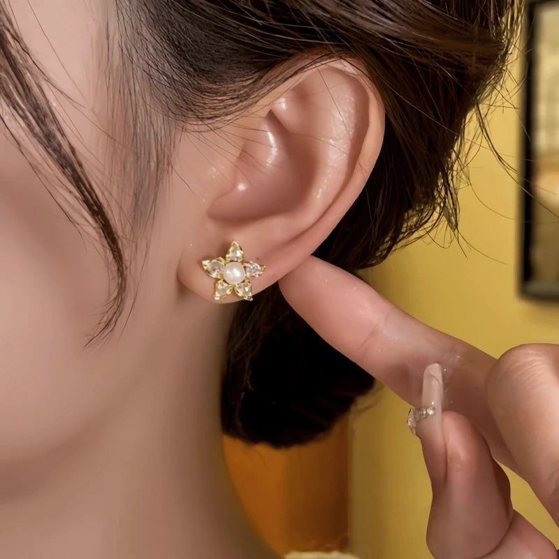 Model showcasing the dangle and style of the 14K Gold-Plated Elegant Zircon Flower Pearl Stud Earrings