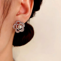 Model showcasing the dangle and style of the 14K Gold-Plated Elegant Zircon Flower Pearl Stud Earrings