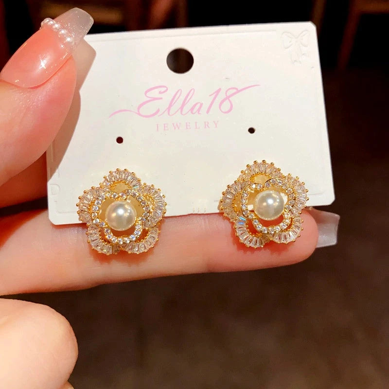 Close-up detail of the sparkling zircons and plating on the gold flower earrings