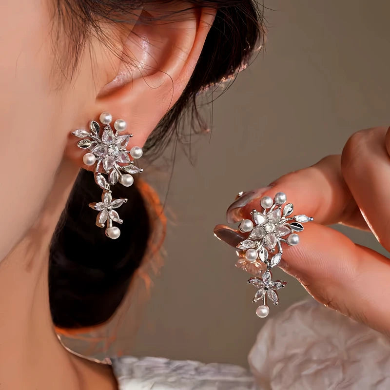 Model showcasing the dangle and style of the 14K Gold-Plated Elegant Zircon Flower Pearl Tassel Earrings
