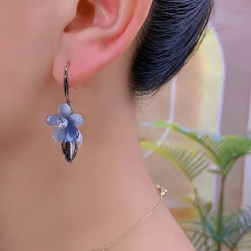 Close-up detail of the sparkling zircons and plating on the gold tassel earrings