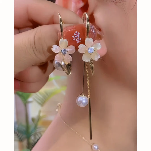 Model showcasing the dangle and style of the 14K Gold-Plated Elegant Zircon Flower Pearl Tassel Earrings