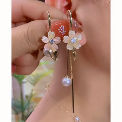 Model showcasing the dangle and style of the 14K Gold-Plated Elegant Zircon Flower Pearl Tassel Earrings