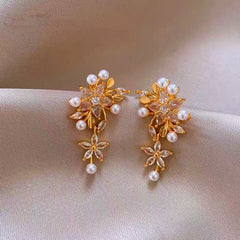 Close-up detail of the sparkling zircons and plating on the gold tassel earrings