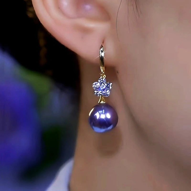 Close-up detail of the sparkling zircons and plating on the purple pearl earrings