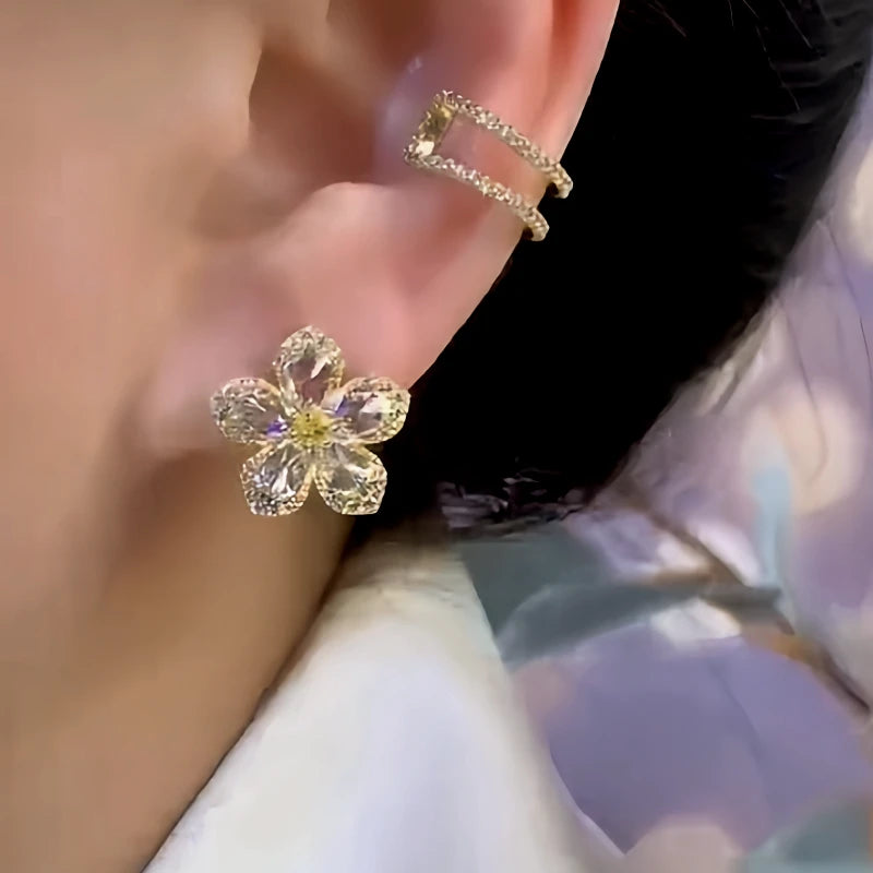 Model showcasing the dangle and style of the 14K Gold-Plated Elegant Zircon Flower Stud Earrings