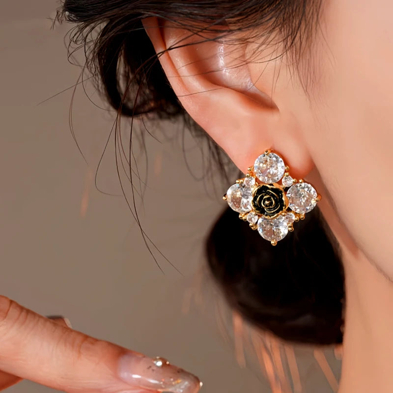 Model showcasing the dangle and style of the 14K Gold-Plated Elegant Zircon Flower Stud Earrings