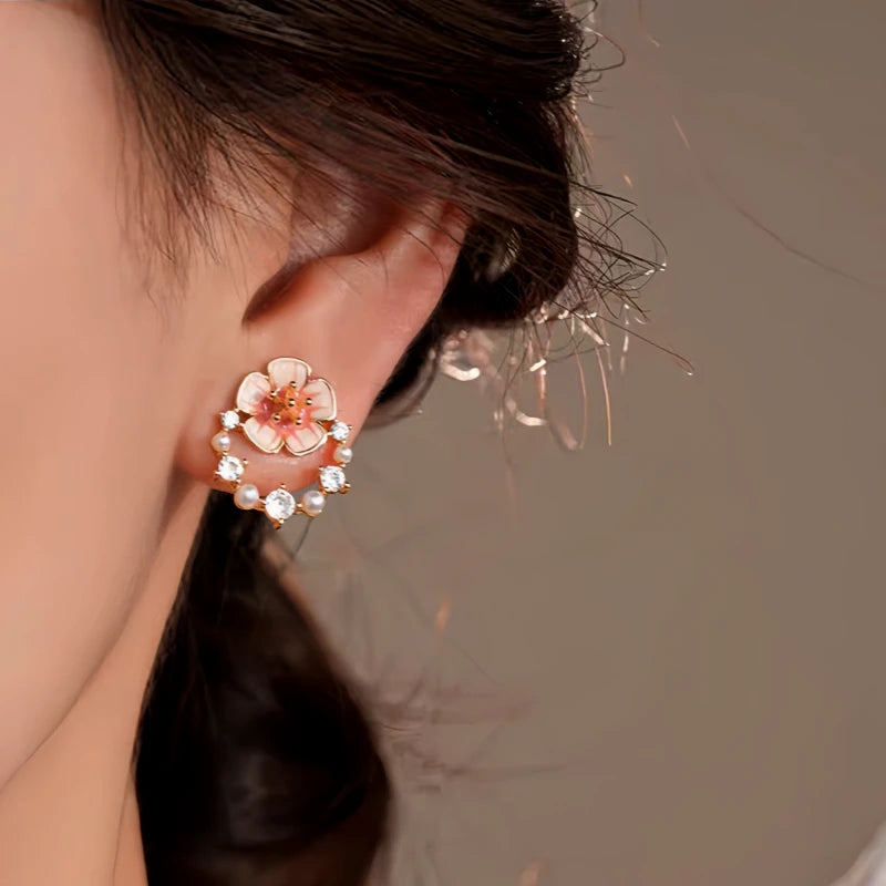 Model showcasing the dangle and style of the 14K Gold-Plated Elegant Zircon Flower Stud Earrings