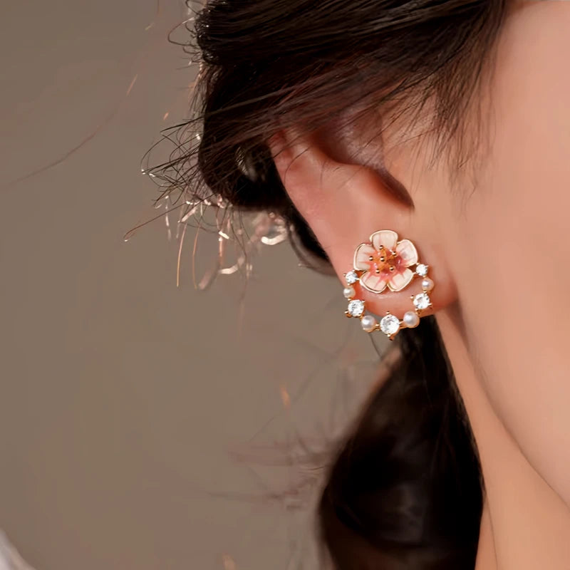 Close-up detail of the sparkling zircons and plating on the gold flower earrings