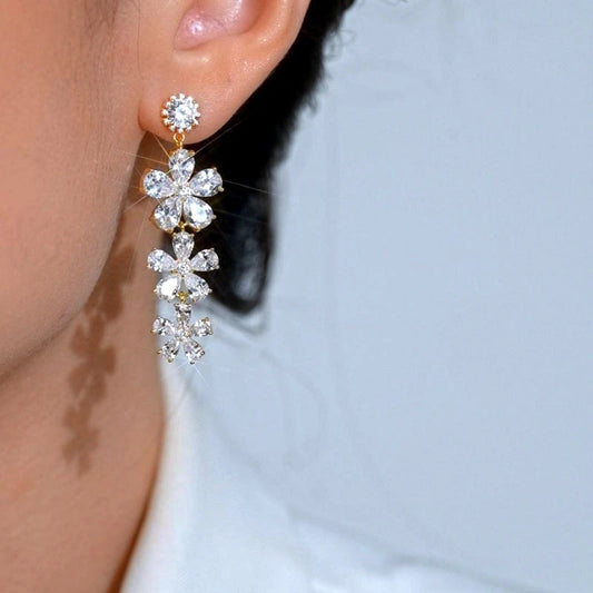 Model showcasing the dangle and style of the 14K Gold-Plated Elegant Zircon Flower Tassel Earrings