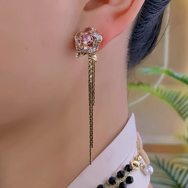 Model showcasing the dangle and style of the 14K Gold-Plated Elegant Zircon Flower Tassel Earrings