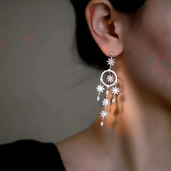Close-up detail of the sparkling zircons and plating on the silver tassel earrings