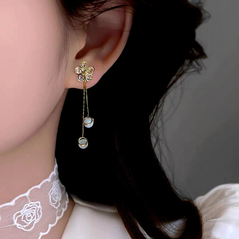 Angled view of the 14K Gold-Plated Elegant Zircon Flower Tassel Earrings
