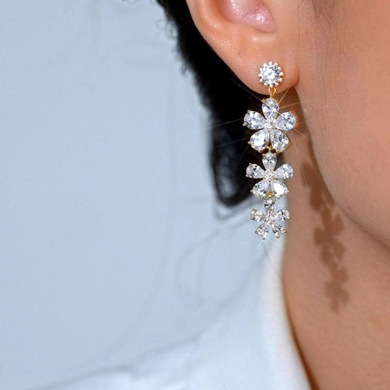 Close-up detail of the sparkling zircons and plating on the gold tassel earrings