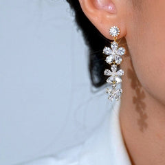 Close-up detail of the sparkling zircons and plating on the gold tassel earrings
