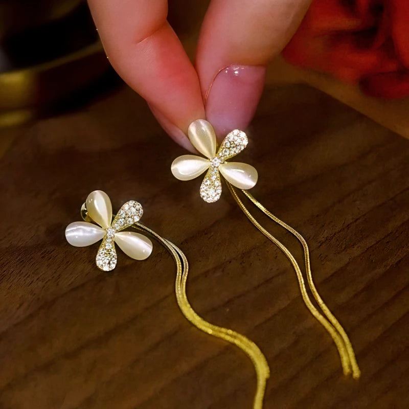 Close-up detail of the sparkling zircons and plating on the gold tassel earrings