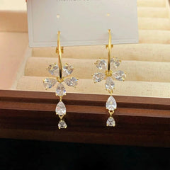 Close-up detail of the sparkling zircons and plating on the gold tassel earrings