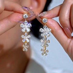Angled view of the 14K Gold-Plated Elegant Zircon Flower Tassel Earrings
