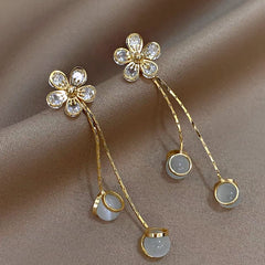 Model showcasing the dangle and style of the 14K Gold-Plated Elegant Zircon Flower Tassel Earrings