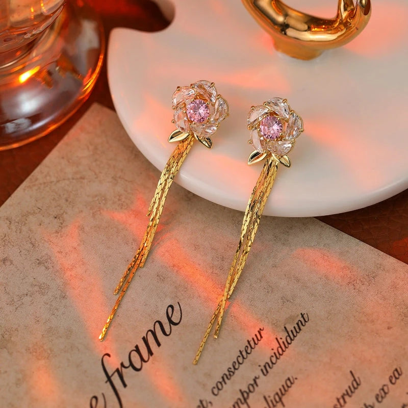 Close-up detail of the sparkling zircons and plating on the gold tassel earrings