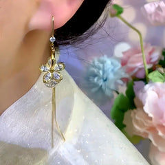 Model showcasing the dangle and style of the 14K Gold-Plated Elegant Zircon Flower Threader Earrings