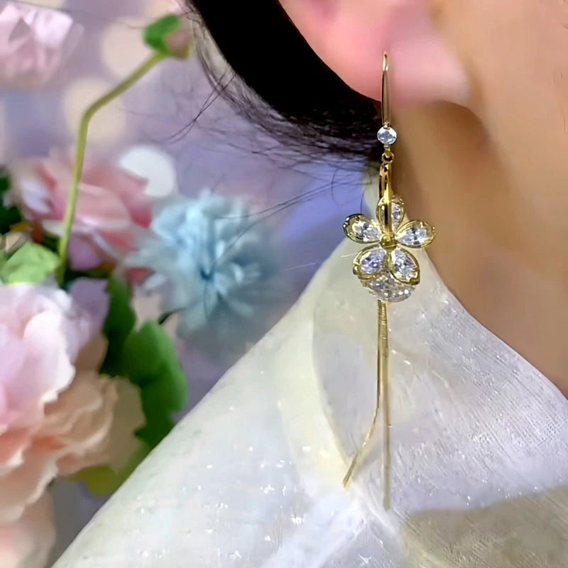 Close-up detail of the sparkling zircons and plating on the gold threader earrings