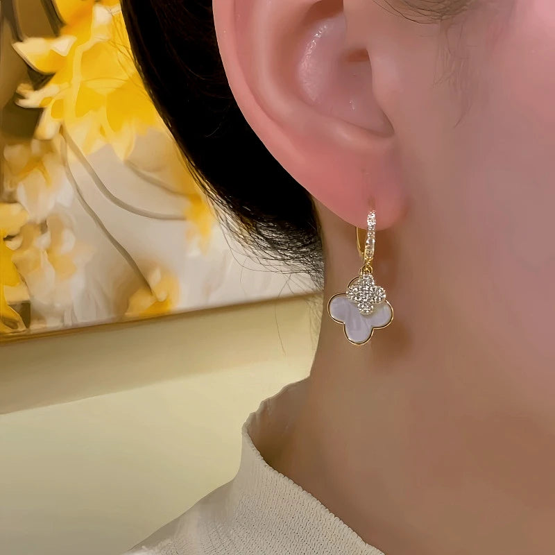 Close-up detail of the sparkling zircons and plating on the clover earrings