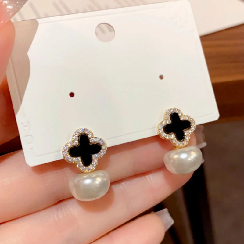 Close-up detail of the sparkling zircons and plating on the clover earrings