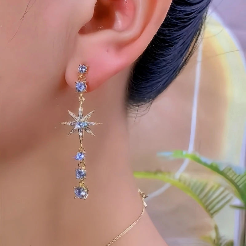 Model showcasing the dangle and style of the 14K Gold-Plated Elegant Zircon Full Diamond Star Tassel Earrings