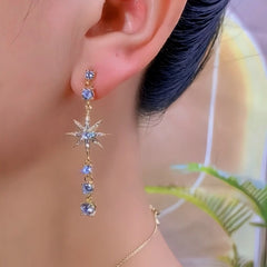 Model showcasing the dangle and style of the 14K Gold-Plated Elegant Zircon Full Diamond Star Tassel Earrings